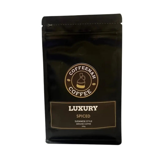 A 200g black stand-up pouch of Coffeenah Coffee Luxury Spiced ground coffee, featuring gold and white branding on a plain white background.